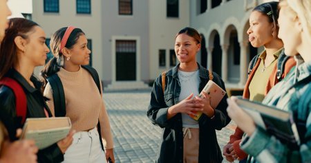 Friends, girls and students with backpack on campus together for exam conversation and college gossip in circle. University, people and diversity with bonding, learning break or happy for scholarshipの写真素材