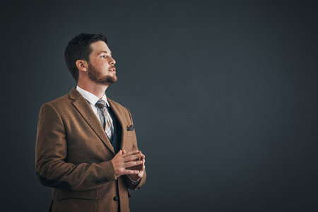 Thinking, serious and man in studio, professional and ideas for education, teacher and confident for college. Mockup space, business person and assistant professor in university and black backgroundの写真素材
