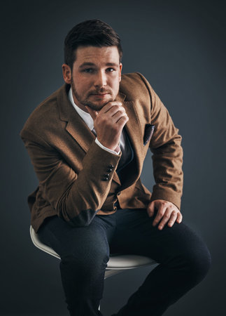 Fashion, studio and portrait of businessman on chair for professional style, corporate or outfit....