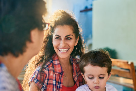 Woman, senior mom and child in garden with smile, bonding and conversation with reunion, visit and relax in summer. Family, mother and boy with talk in backyard, memory and happy with love in Greeceの写真素材
