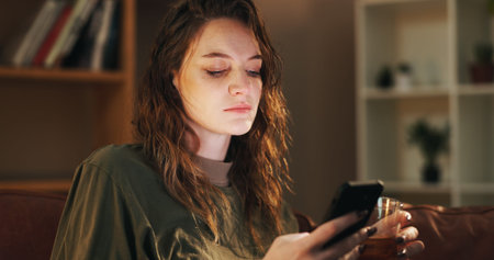 House, alcohol and woman with smartphone, depression and mental health with typing in living room....