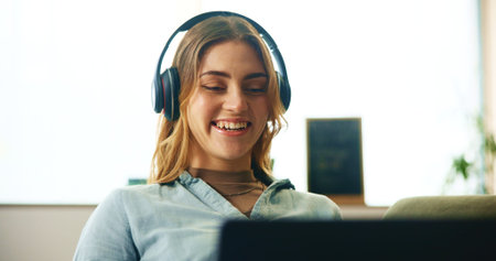 Remote work from home, pc and woman with headphones, virtual meeting and communication. Happy...