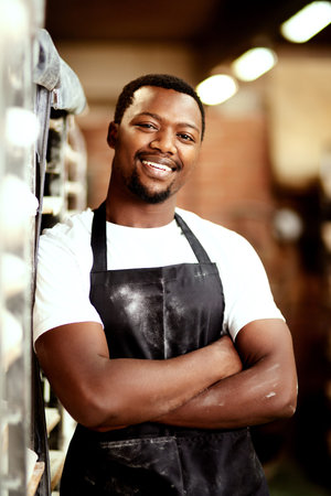 Black man, portrait and bakery with confidence for production, fresh bread or pastry by trolley at...