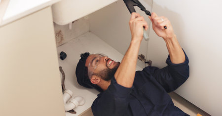 Plumber, house and handyman with maintenance, repair and skills with equipment, fixing and small business. Person, entrepreneur and industry with tools, contractor and service for home renovationの写真素材