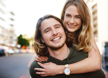 Piggyback, portrait or happy couple on holiday in city to travel for relationship, weekend or tourism. Smile, outdoor trip and excited people in urban town street for adventure or vacation in Miamiの写真素材