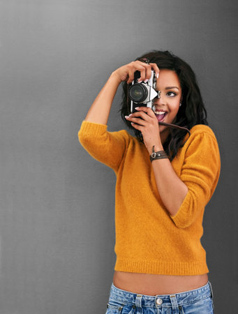 Woman, photographer and happy with vintage camera in studio with tech for art, magazine or paparazzi...