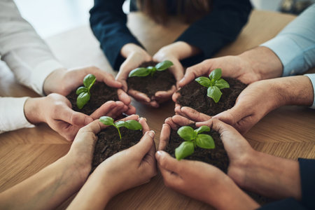 Sustainable, hands and business people with plant in soil for unity, collaboration and support in company growth. Team, eco friendly and group of employees with leaf sprout in fertilizer for startup.の写真素材
