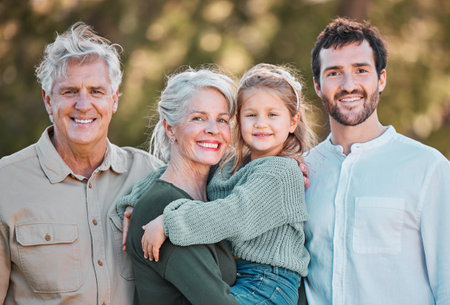 Generations, family and happy in garden on portrait for gathering, visit and bonding in Germany. People, dad and grandparents with girl for support with smile for care, trust and unity on breakの写真素材