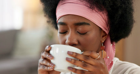 Girl, coffee and drinking to relax in home with morning routine, start day and peaceful in...