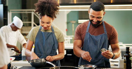 Cooking, students and learning in kitchen, chef and team with skills, culinary or preparation of meal. Restaurant, apprentice and people with recipe, smile and talent in hospitality, cuisine or apronの写真素材