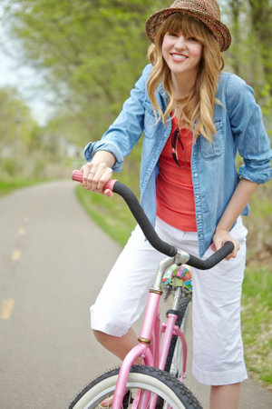 Outdoor, active and woman with bicycle, travel and eco friendly with reduced emissions and weekend. Commuting, happy and person with transport, ride and cycling in morning, portrait and fun with bikeの写真素材