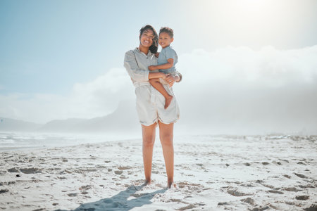 Love, portrait and mother with son at beach for travel destination, summer and vacation. Relax, tropical and adventure with woman and child for family holiday, bonding and happiness togetherの写真素材