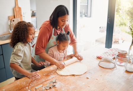 Happy, baking and kids with mom in kitchen with dough, cooking and youth learning in home. Girls, rolling pin and breakfast with care, support and fun with culinary development and love togetherの写真素材