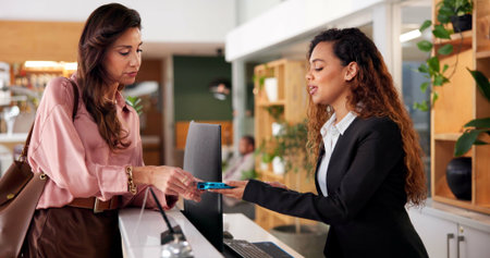 Hotel, receptionist and woman with card machine for booking, guest room service and reservation....