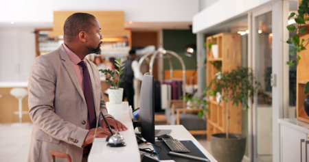 Hotel, business man and waiting at reception desk for check in, arrival and reservation booking with luggage. Professional, customer and delay with service at lodge for accommodation and checkoutの写真素材