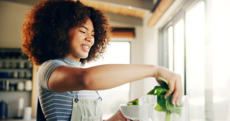 Smile, vegetables and spinach with blender in kitchen with organic ingredients, prepare smoothie and...