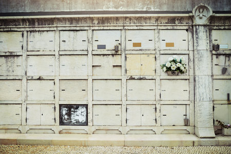 Cemetery, burial and tomb with wall, outdoor and mausoleum with tradition, monument and empty. Memorial stone, structure and graveyard with history, spiritual and ancient with funeral and New Orleansの写真素材