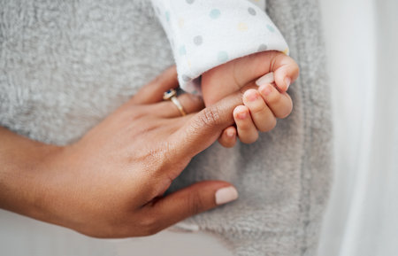 Holding hands, zoom and love with mother, baby and support for growth, development and motor skills. Female person, child and care in home or living room with together, bonding and comfort as familyの写真素材