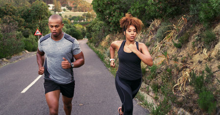 Couple, runner and road in nature with training, speed and outdoor with progress, fitness and wellness. Woman, man and partnership with workout, exercise and challenge by mountains in Costa Ricaの写真素材
