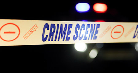 Crime scene, police tape and caution at night for investigation with safety warning, danger and...