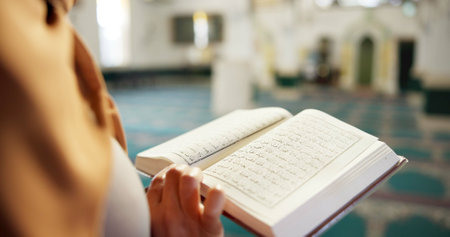 Muslim woman, hands and arabic with quran or book of allah at mosque for recitation, praying or dua in temple. Female person, closeup or arab with islamic testament, holy scripture or faith for godの写真素材