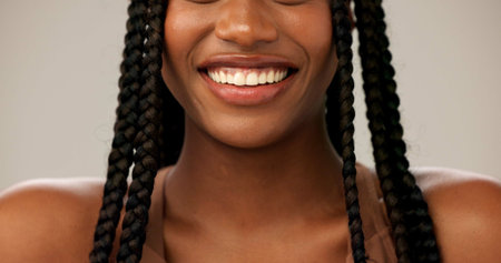Closeup, teeth whitening and woman with smile, beauty and dental hygiene on gray studio background....