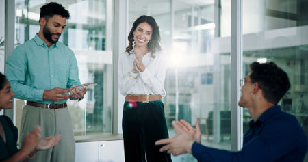 Trophy, winner and applause with business people in workshop for celebration, congratulations and award. Prize, promotion and achievement with employee in meeting for reward, bonus and thank youの写真素材