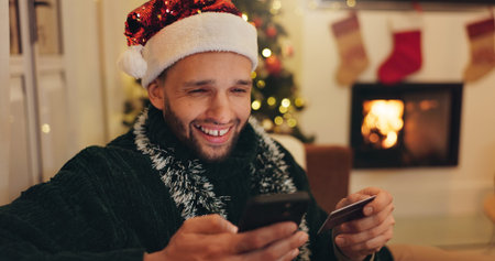 Christmas, phone and happy man with credit card for online shopping, digital purchase or gifts...