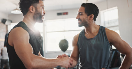 Fitness, men and handshake in gym for workout success, wellness challenge or training teamwork. Athlete, personal trainer or hand gesture at sports center for exercise progress or performance supportの写真素材