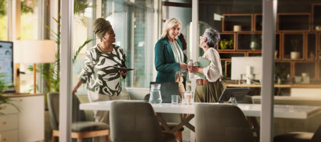Teamwork, women and business people in office, conversation and planning for project. Empowerment, creative agency and group in meeting, discussion and brainstorming for proposal, smile and feedbackの写真素材