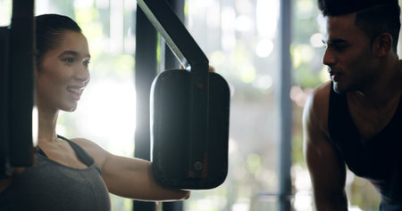 Chest exercise, equipment and personal trainer with woman in gym for physical improvement or...