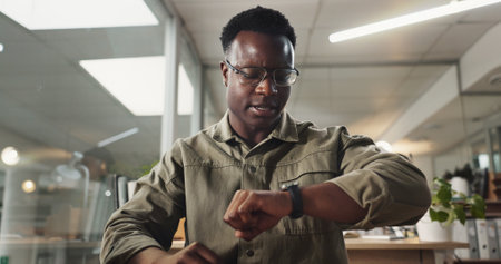 Black man, stress or watch in office for deadline, time management or anxiety for online meeting with POV. Accountant, frustrated or late in workplace with crisis, worry or missed virtual appointmentの写真素材