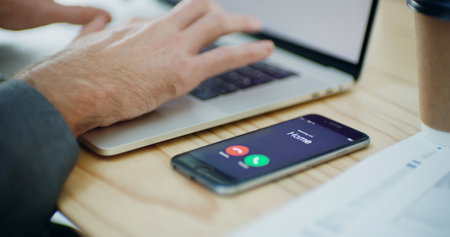 Phone call, screen and hands of person in office for communication, contact and consultant. Laptop, typing and networking with closeup of employee and mobile at desk for ui, technology and connectionの写真素材