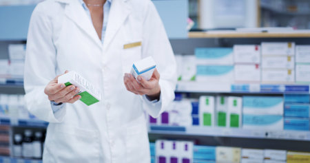 Pharmacist, hands or box with pills in pharmacy for inventory check, prescription order or drugs dispensary. Medical, professional or supplement medication in store for pharmaceutical stock or healthの写真素材