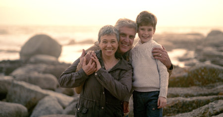 Sunrise, ocean and portrait of grandparents with kid for bonding, fun weekend and relax at beach....