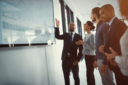 Presentation, TV screen and business people in office with finance statistics for revenue or capital gain. Meeting, data and team of financial consultants with profit growth investment in company.の写真素材