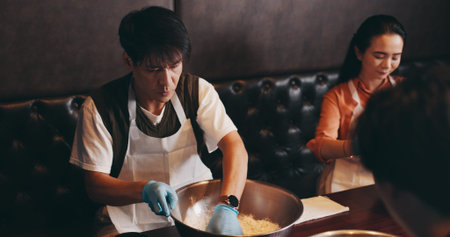 Cooking, man and woman in class with chef, romantic date and bonding together at Asian food...