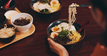 Asian restaurant, ramen and people with noodles, meat and vegetables for dinner, lunch and supper. Culinary, traditional cuisine and customer for healthy eating, nutrition and gourmet dish in Japanの写真素材