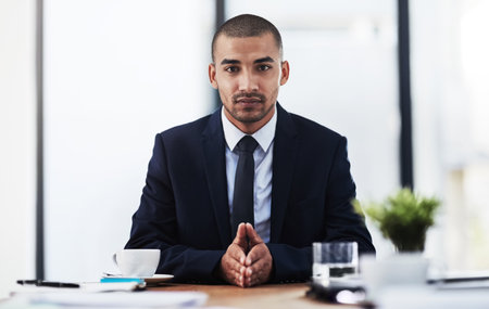 Serious, office and portrait of business man with job opportunity, company pride and ambition. Corporate worker, professional and person at desk waiting for meeting, financial consulting and workingの写真素材