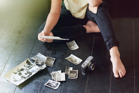 Hands, woman and camera with vintage photographs with inspiration for art project, memories and collection. Female person, freelancer and artist with career, skill and talent for art and creativeの写真素材