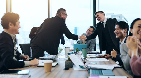Business people, handshake and success in office as group for contract, achievement or investment. Team, finance and partnership for deal, collaboration and meeting in project management or corporateの写真素材