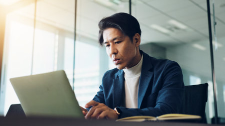 Typing, research and man with laptop, office and planning for finance, bookkeeper and professional. Digital, auditor and budget for company, accounting and analysis of investment, online and Japanの写真素材