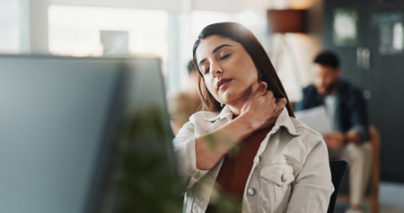 Business, computer and woman in office, neck pain and muscle tension with stress. Person, magazine editor and journalist in workplace, pc and tired with shoulder strain, inflammation and burnoutの写真素材