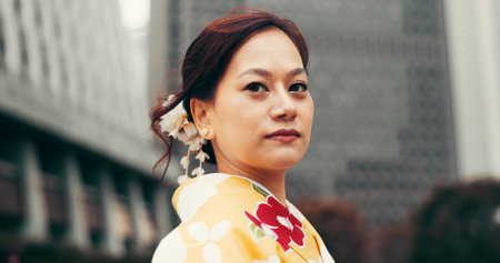 Portrait, kimono and travel with Japanese woman in city for heritage, festival celebration and culture. Traditional clothes, fashion and respect with asian person and outdoor for pride and peaceの写真素材