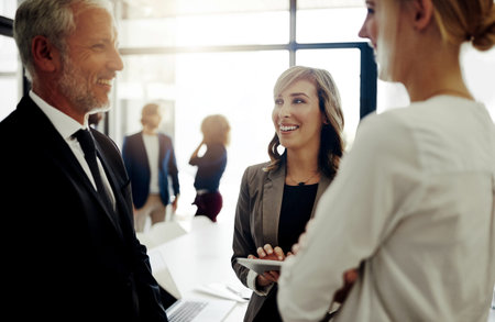Business people, tablet and conversation in office for teamwork, discussion or brainstorming. Women,...