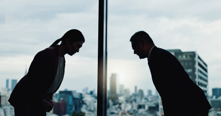 Japanese people, bow and meeting at window for business, collaboration and culture greeting in office. Corporate team, traditional welcome or gesture in agency for partnership, cooperation or respectの写真素材