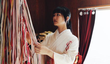 Fashion designer, workshop and Asian woman with fabric for kimono, traditional clothes and indigenous style. Small business, boutique and person with textile and material for tailor service in Japanの写真素材
