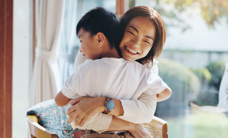 Japanese, mother and hug child at house with love, care and bonding together for childhood development. Smile, woman and boy with embrace for security, family relationship and weekend visit in Japanの写真素材