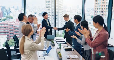 Business, people and handshake with applause in meeting for investment deal, partnership contract and welcome. Japanese firm, finance staff and clapping hands for merger success and b2b onboardingの写真素材