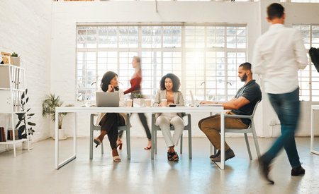 Boardroom, busy and project management with business people in office for creative occupation. Collaboration, motion blur and walking with employee team in workplace for design or developmentの写真素材